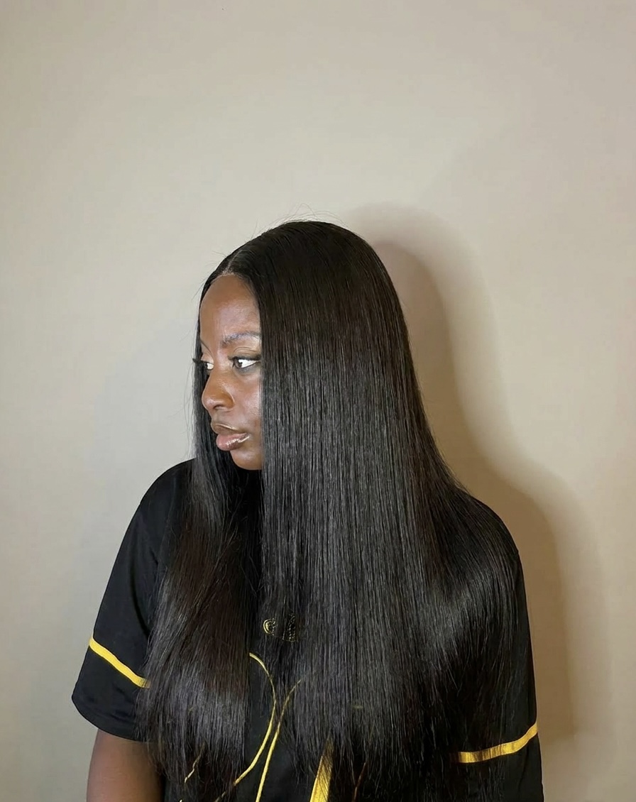 A Maison Mayari client wearing a long, sleek straight wig